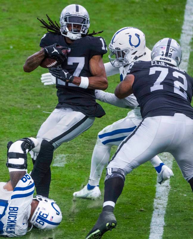 Raiders wide receiver Davante Adams (17) battles for more yards over the Indianapolis Colts def ...