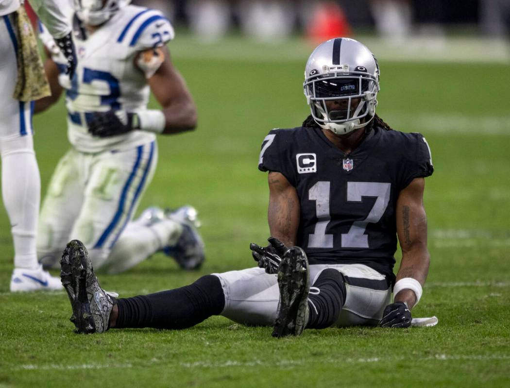 Raiders wide receiver Davante Adams (17) remains on the field sitting after a play break up by ...