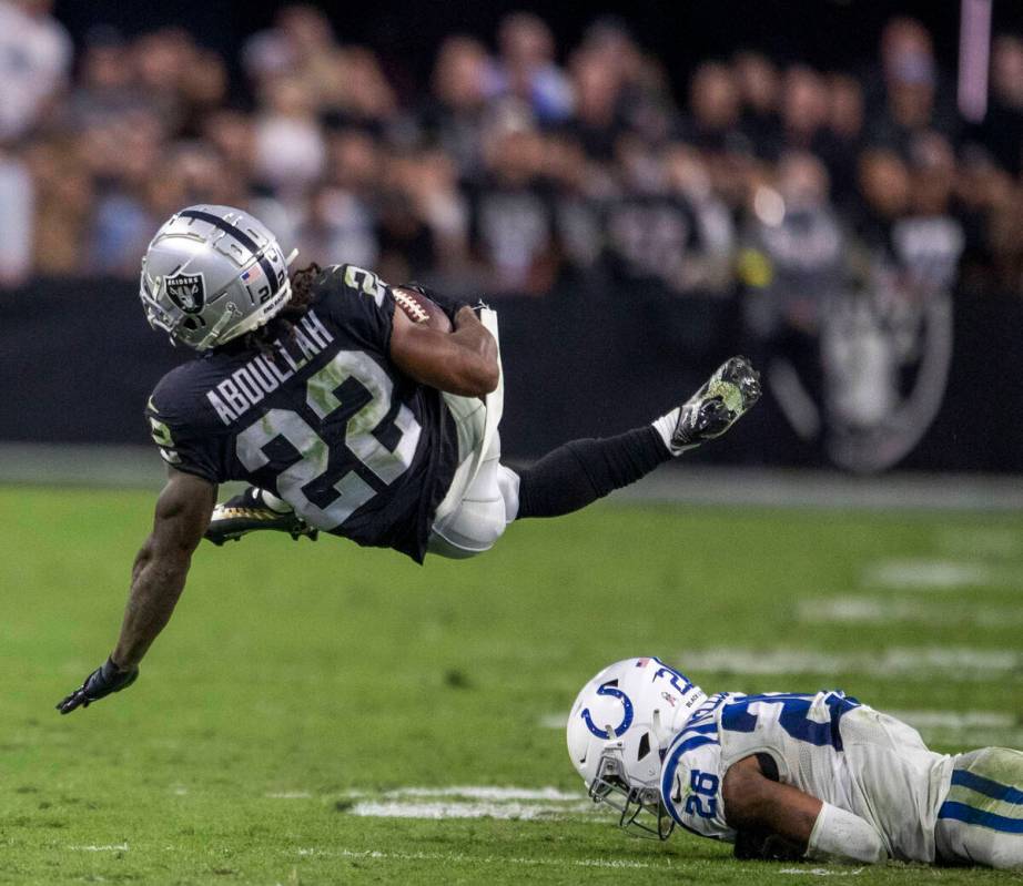 Las Vegas Raiders running back Ameer Abdullah (22) comes down after being hit by Indianapolis C ...