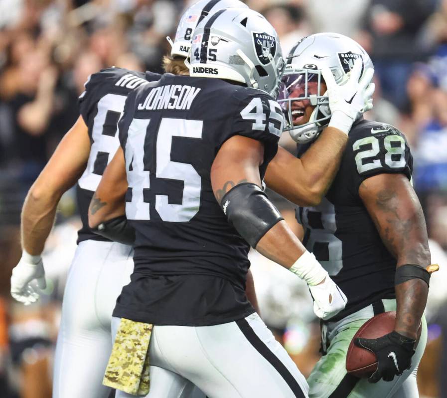 Raiders running back Josh Jacobs (28) celebrates his touchdown with teammates during the second ...