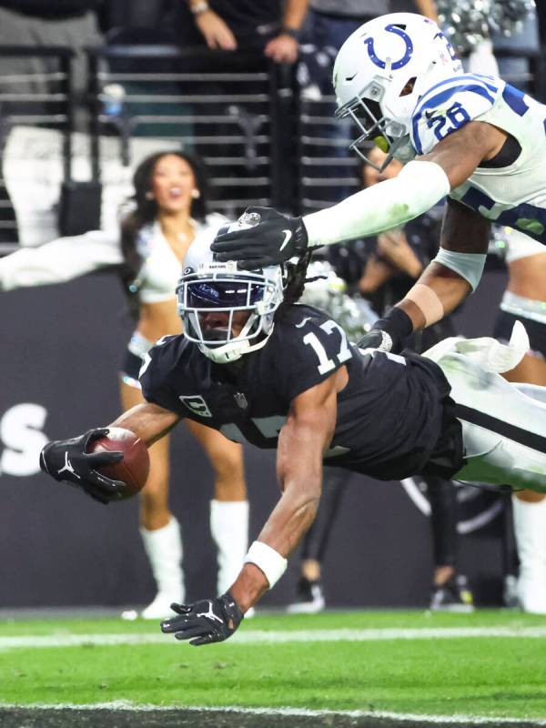 Raiders wide receiver Davante Adams (17) scores a touchdown under pressure from Indianapolis Co ...