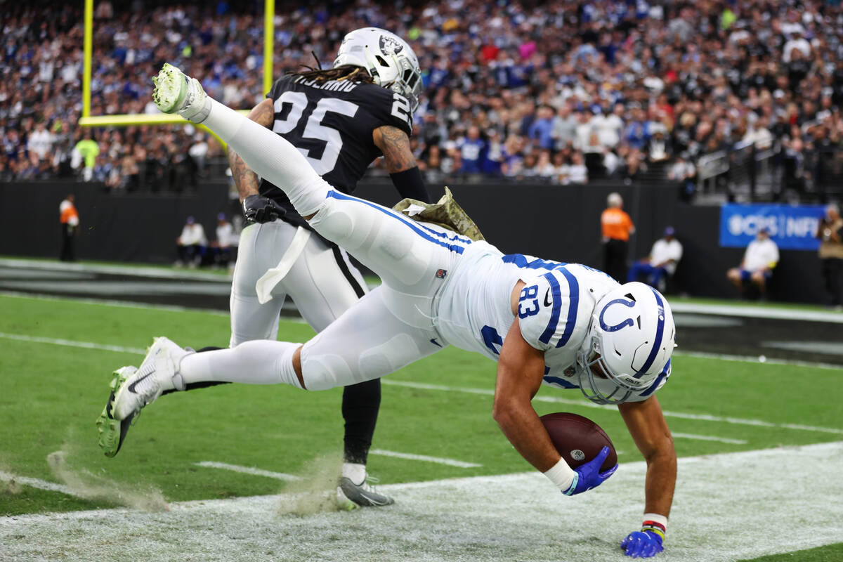 Raiders safety Tre'von Moehrig (25) tackles Indianapolis Colts tight end Kylen Granson (83) out ...