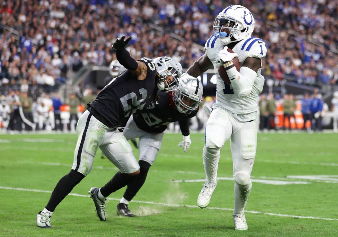 Indianapolis Colts wide receiver Parris Campbell (1) runs past Raiders safety Tre'von Moehrig ( ...