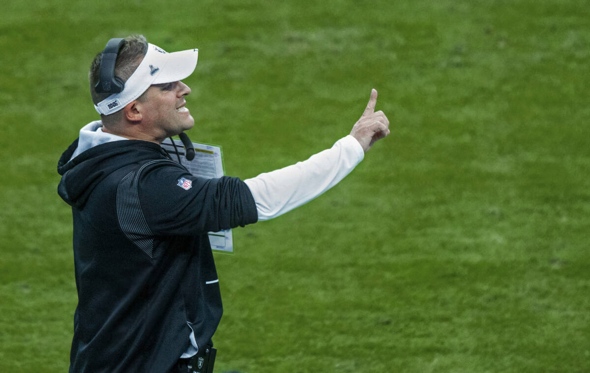 Raiders Head Coach Josh McDaniels makes a call on the sidelines versus the Indianapolis Colts s ...