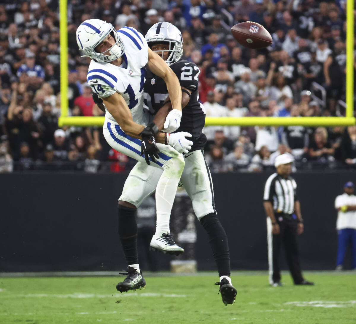 Raiders cornerback Sam Webb (27) breaks up a pass intended for Indianapolis Colts wide receiver ...