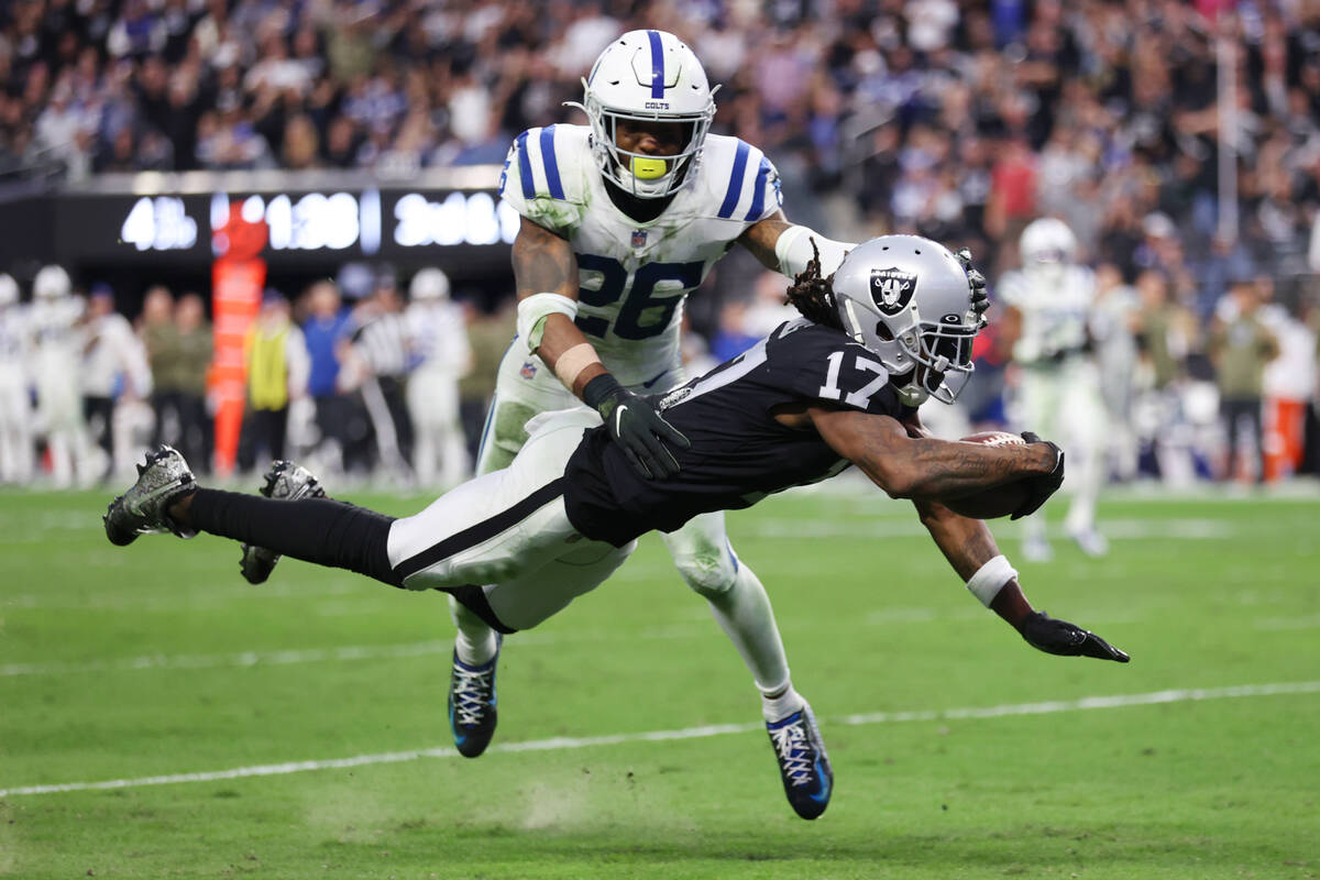 Raiders wide receiver Davante Adams (17) dives for a touchdown under pressure from Indianapolis ...