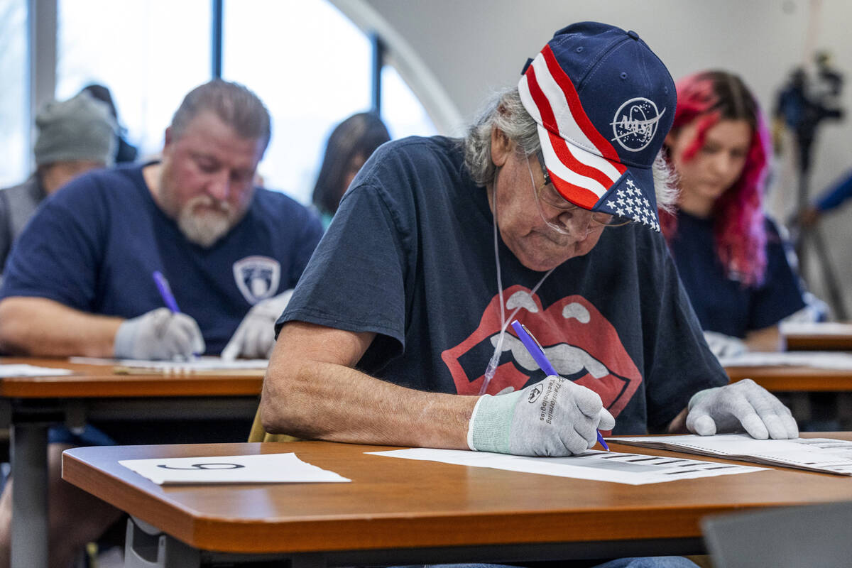 Volunteers resume hand counting ballots in Nye County at the Valley Conference Center on Thursd ...