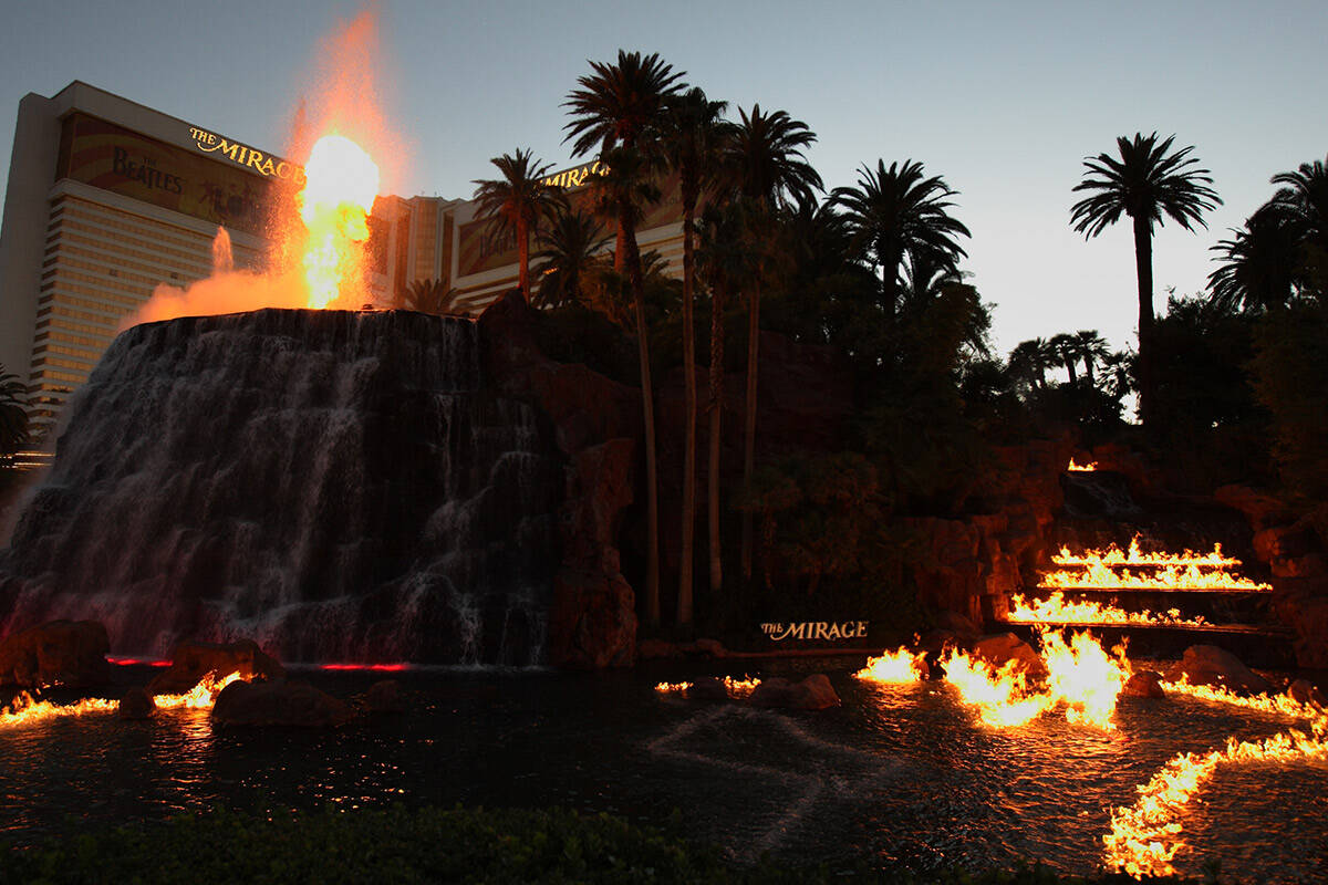 Fire belches from the volcano as flames dance across the surface of the water in front of The M ...