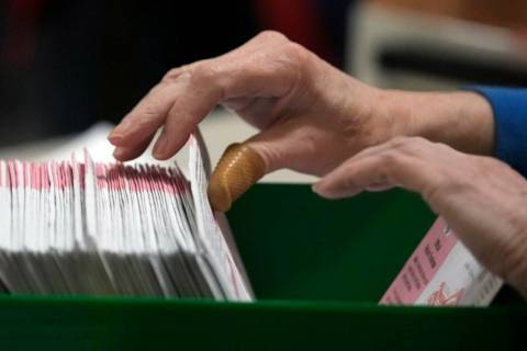 Election workers process ballots at the Clark County Election Department, Thursday, Nov. 10, 20 ...