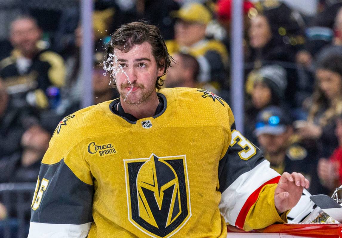 Golden Knights goaltender Logan Thompson (36) spits some water during a timeout versus the San ...