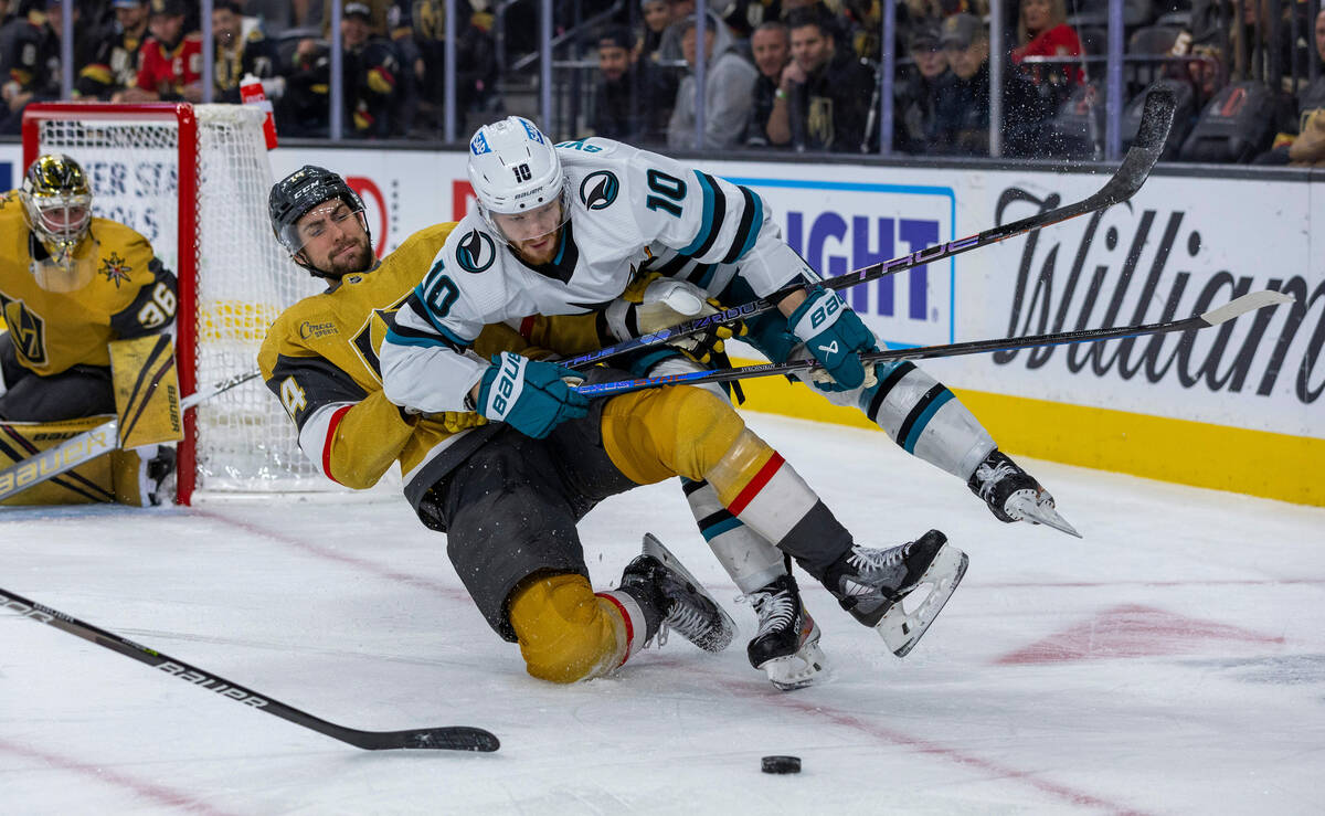 Golden Knights defenseman Nicolas Hague (14) takes down San Jose Sharks left wing Evgeny Svechn ...