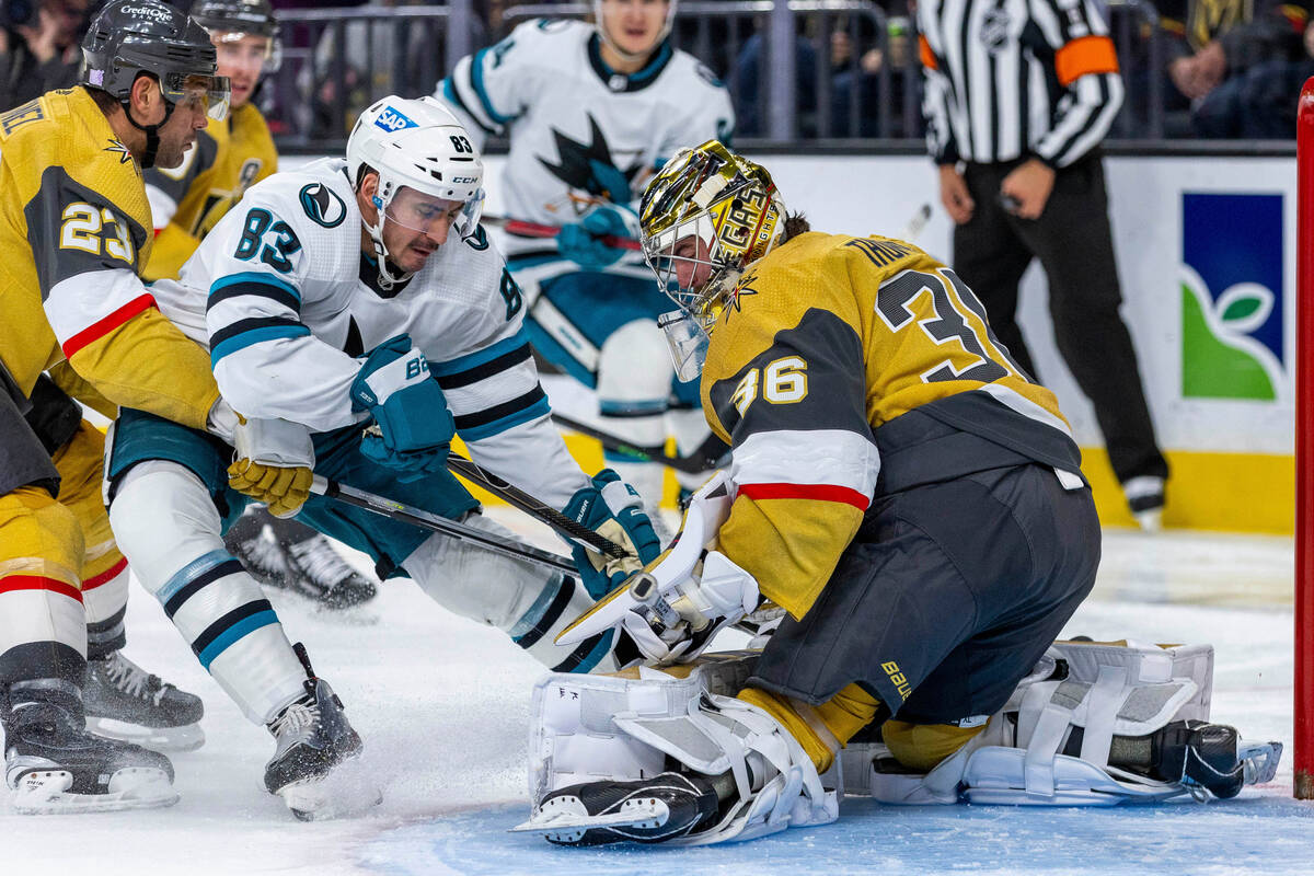 Golden Knights goaltender Logan Thompson (36) makes another stop over San Jose Sharks left wing ...