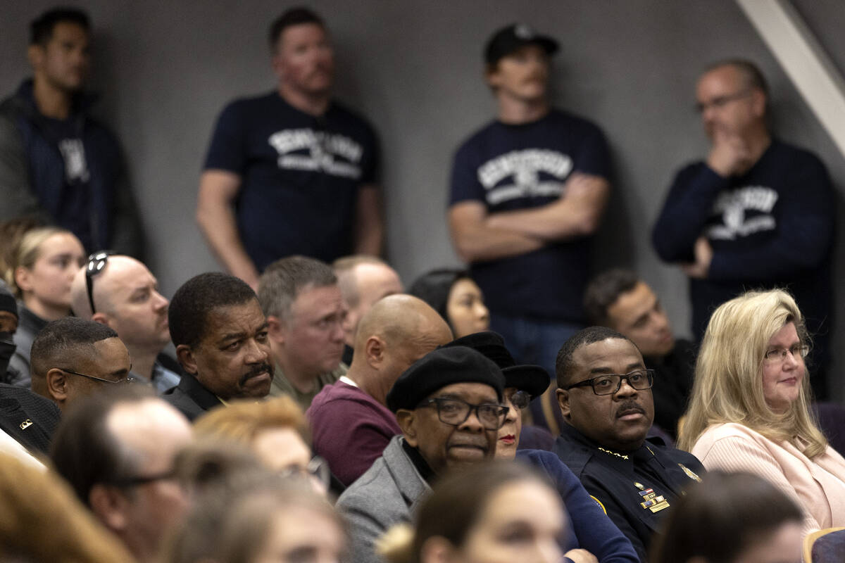 Henderson Chief of Police Thedrick Andres, second from right, listens to public commentary duri ...