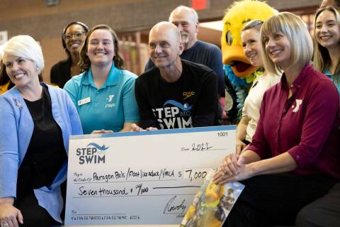 Olympic Gold Medalist Rowdy Gaines, center, poses with the beneficiaries of Step Into Swim's do ...
