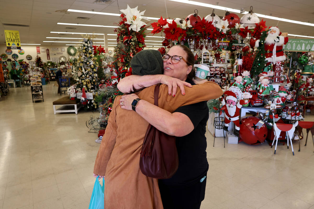 Co-owner Beth Tom, right, hugs customer Brittney Aquino of Henderson shop at Santa’s Wrap hom ...