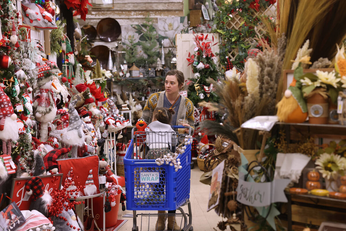 Bethany Delgadillo and her daughter Elowyn, 2, shop at Santa’s Wrap home decor and furniture ...