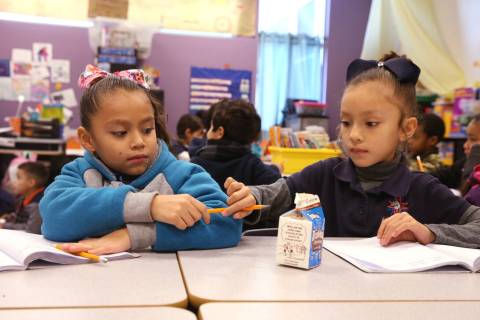 E'liana Trujillo borrows a pencil from Maryah Villezcas in Shamika Abbott's first-grade class a ...