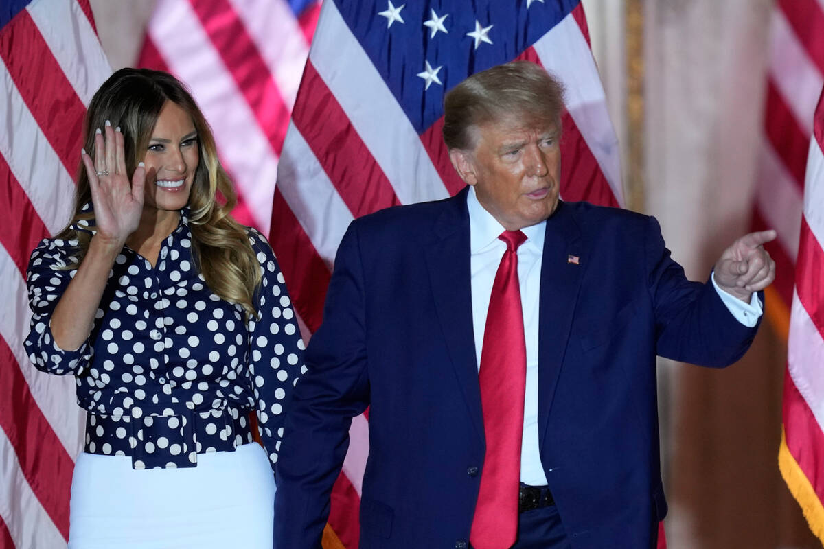 Former President Donald Trump stands on stage with former first lady Melania Trump after announ ...