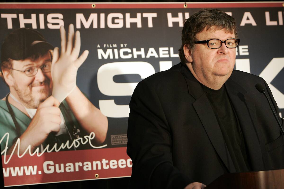 FILE - Filmmaker Michael Moore holds a town hall-style meeting at the Palace Theater in Manches ...
