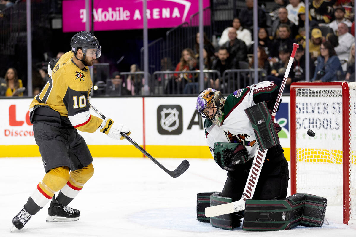 Coyotes goaltender Karel Vejmelka (70) saves a shot on goal by Golden Knights center Nicolas Ro ...