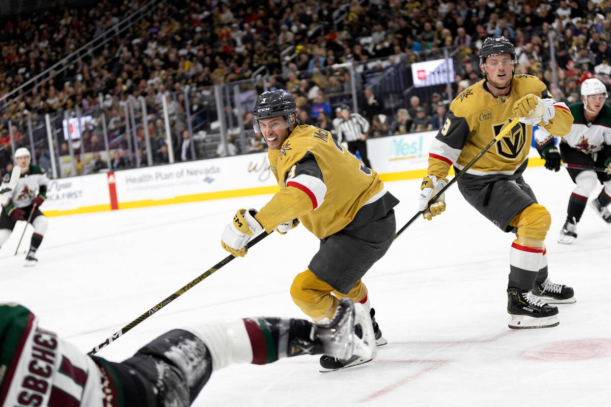 Coyotes defenseman Shayne Gostisbehere (14) takes a hit from Golden Knights defenseman Brayden ...