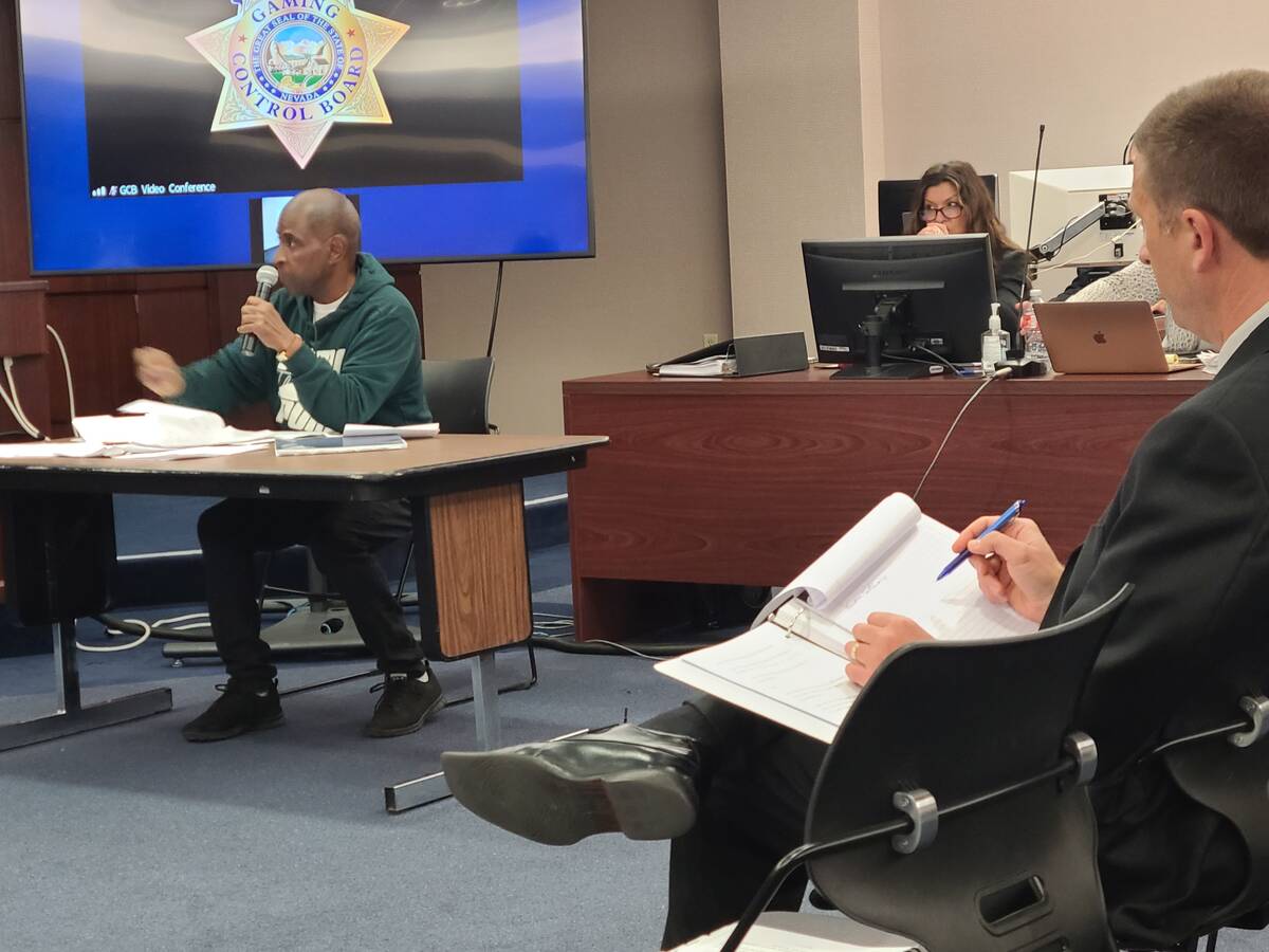 With Deputy Attorney General John Michela reviewing documents in the foreground, Leonard Morgan ...