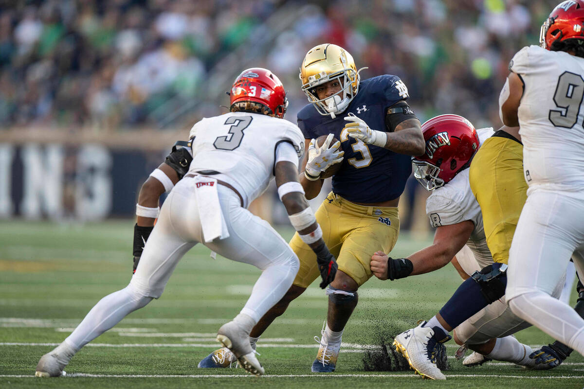 Notre Dame running back Logan Diggs (3) tries to get past UNLV defensive back Johnathan Baldwin ...