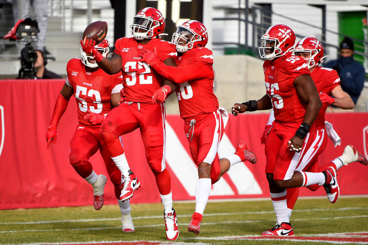 DC Defenders linebacker Jonathan Celestin (52) celebrates with teammates after scoring a touchd ...