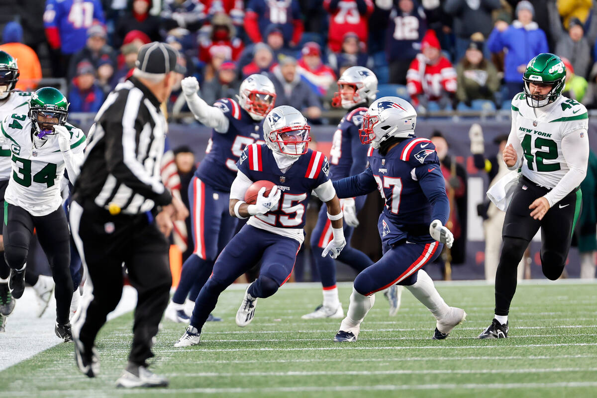 New England Patriots returner Marcus Jones (25) evades the New York Jets defense to return a pu ...