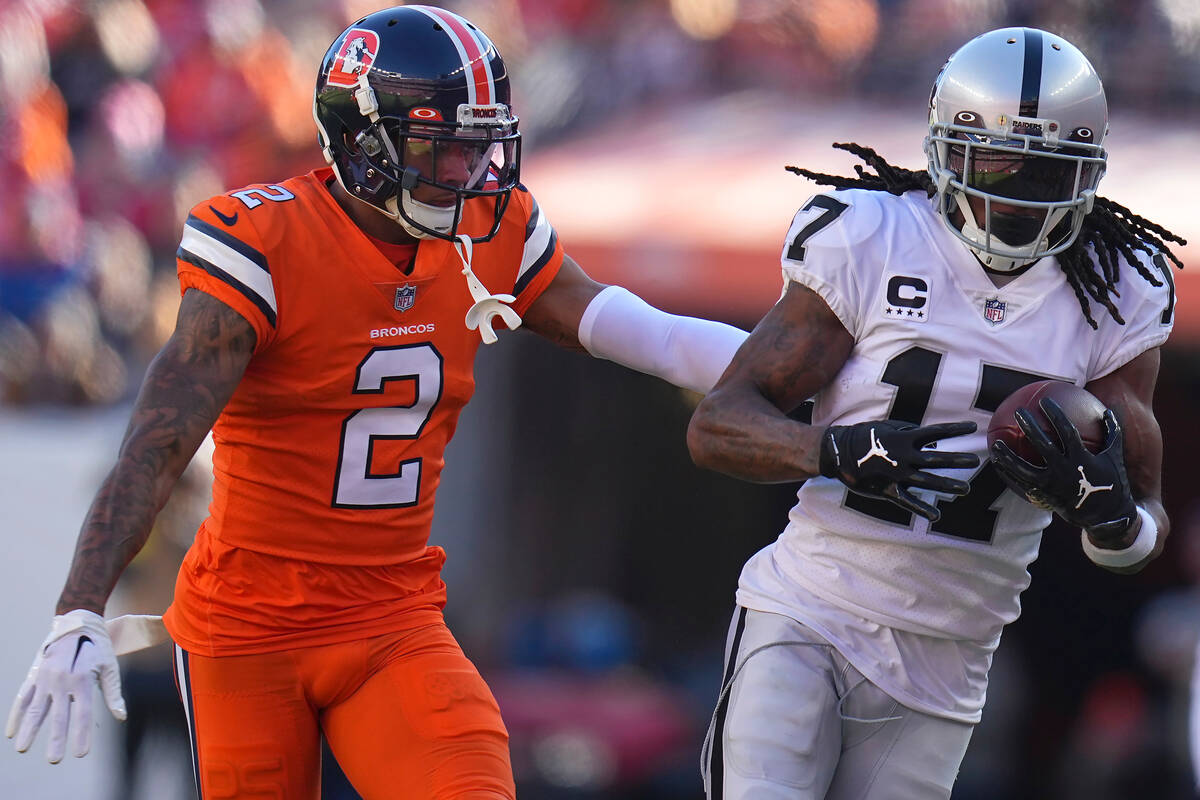 Las Vegas Raiders wide receiver Davante Adams (17) runs against Denver Broncos cornerback Pat S ...