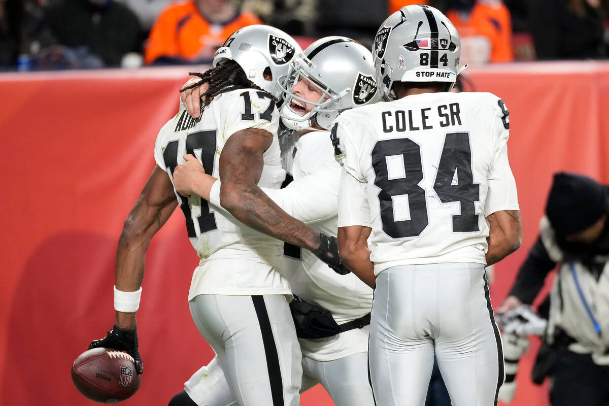 Las Vegas Raiders quarterback Derek Carr, middle, celebrates with wide receiver Davante Adams ( ...