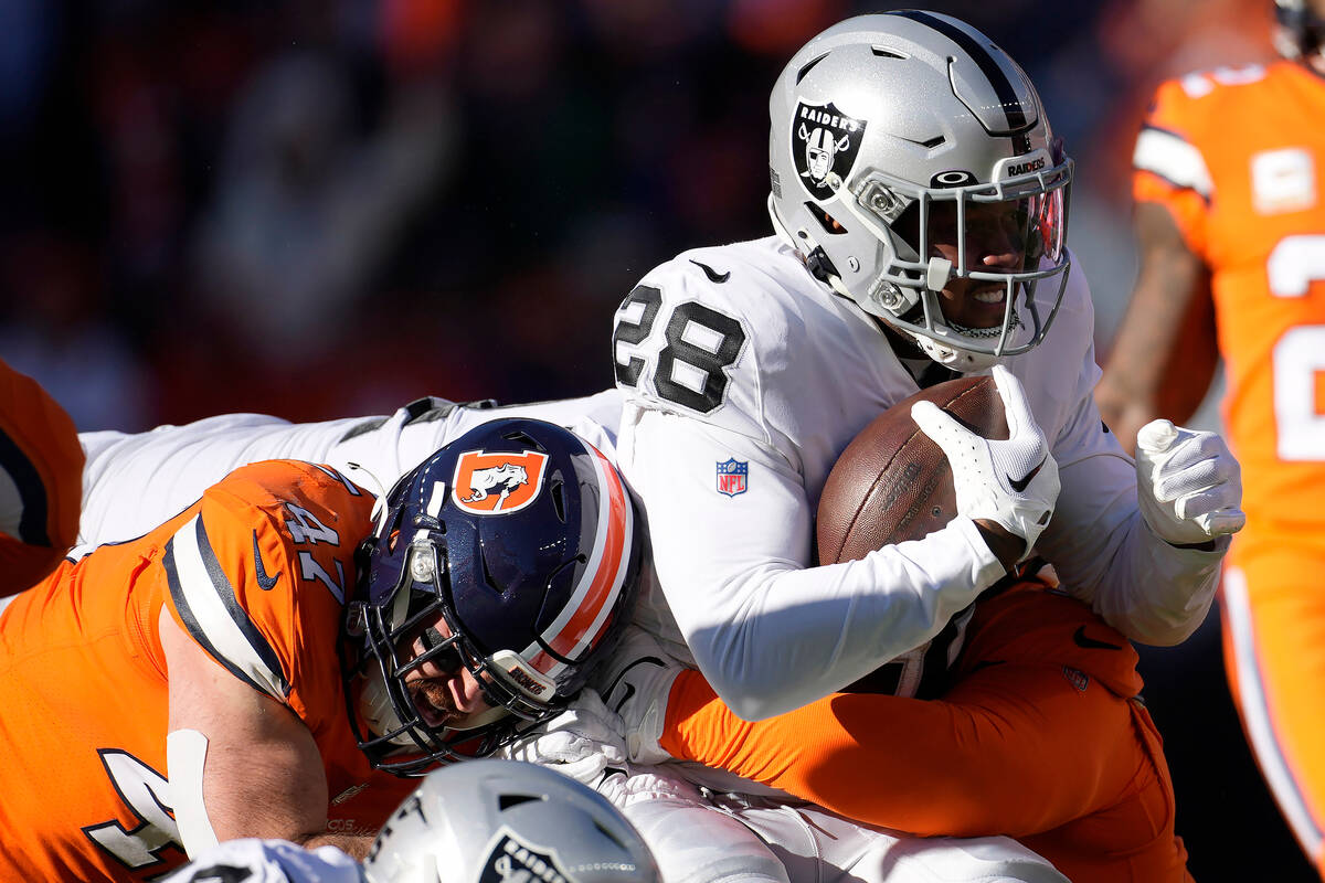 Las Vegas Raiders running back Josh Jacobs (28) runs against the Denver Broncos during the firs ...