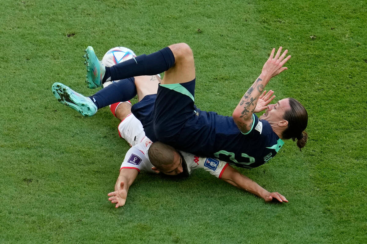 Australia's Jackson Irvine falls on Tunisia's Aissa Laidouni during the World Cup group D socce ...