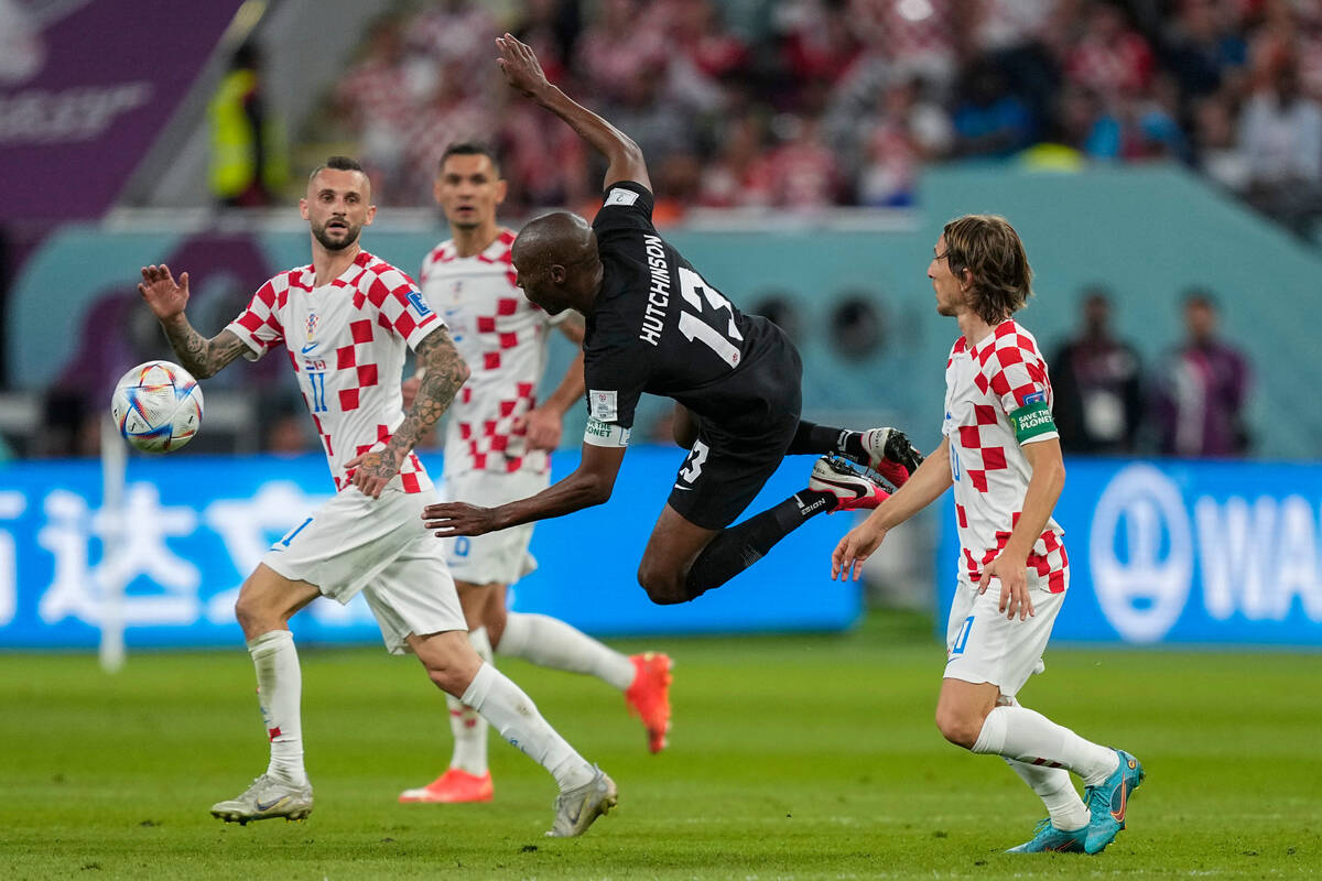 Canada's Atiba Hutchinson, center, vies for the ball with Croatia's Marcelo Brozovic, left, and ...