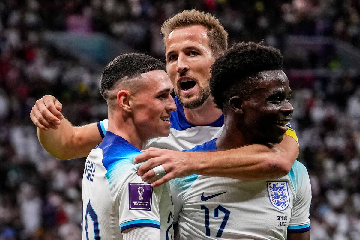 England's Bukayo Saka, right, celebrates with his teammate England's Harry Kane, center, and En ...