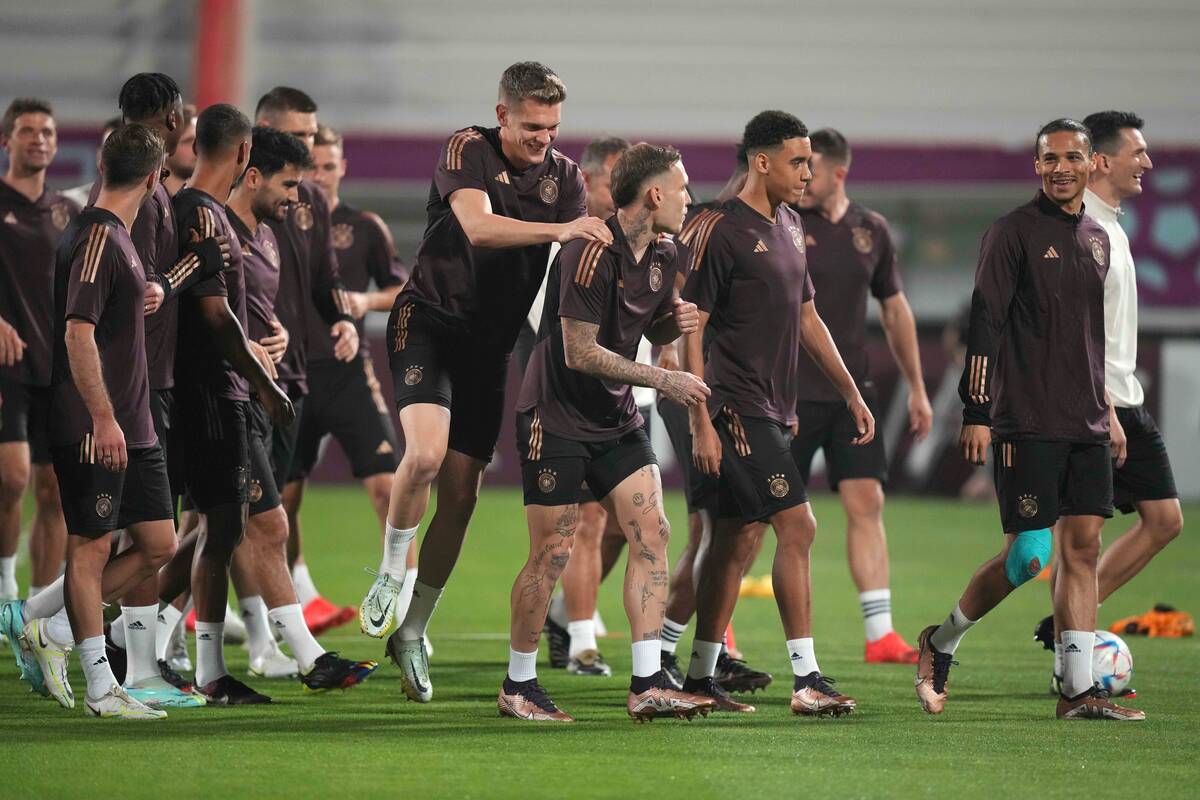 Germany's David Raum, center, talks to Leroy Sane, right, while Matthias Ginter, center top, jo ...