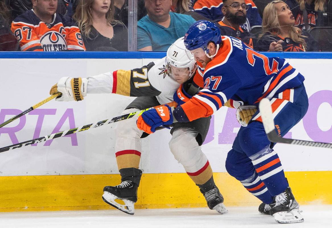 Vegas Golden Knights' William Karlsson (71) is checked by Edmonton Oilers' Brett Kulak (27) dur ...