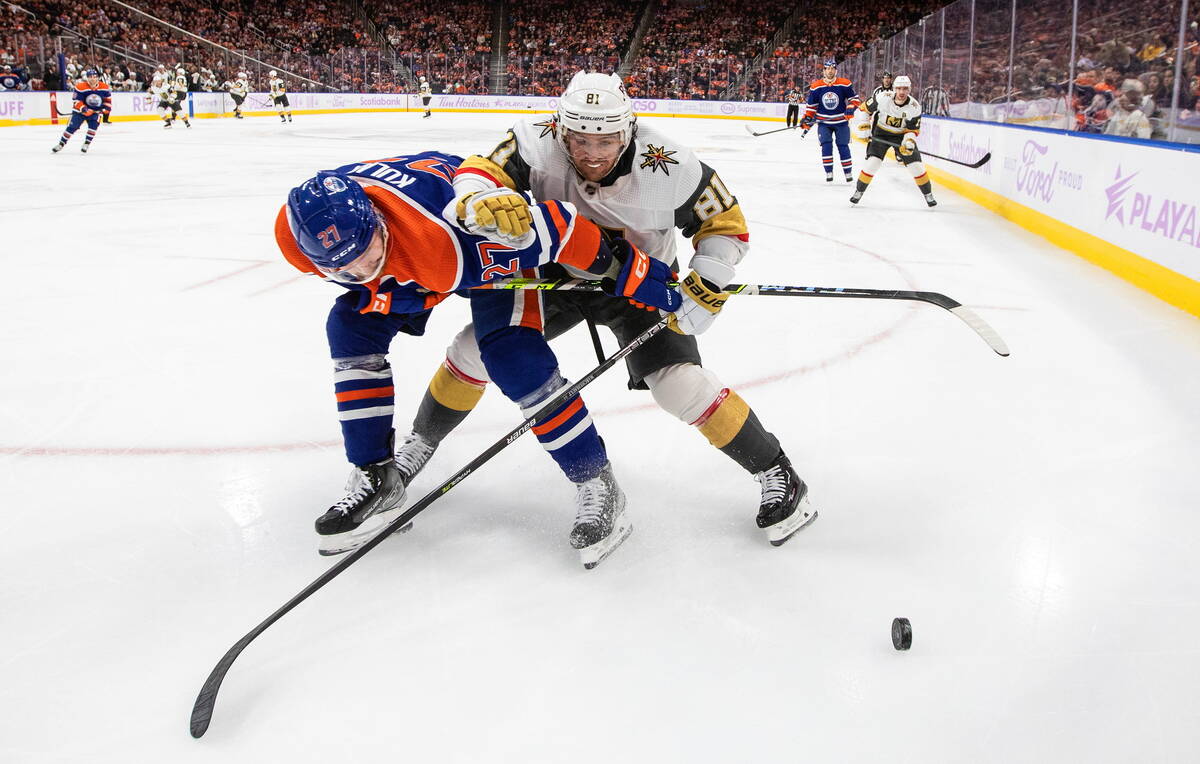 Vegas Golden Knights' Jonathan Marchessault (81) and Edmonton Oilers' Brett Kulak (27) vie for ...