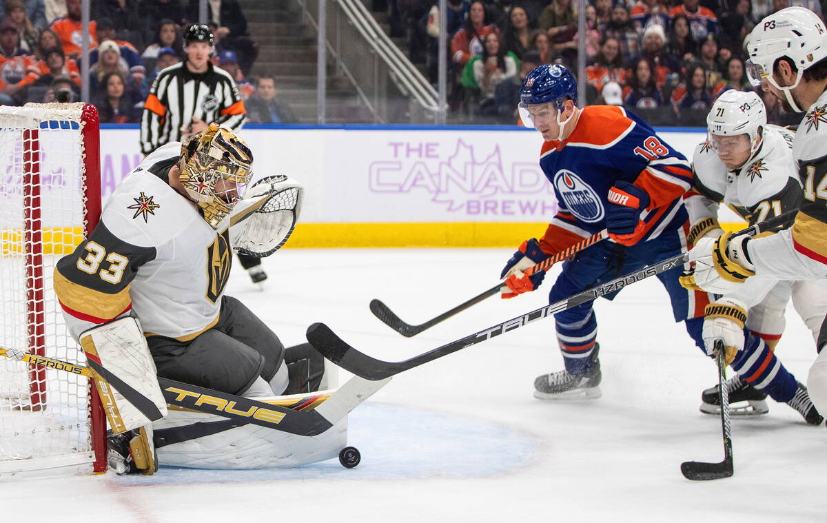 Vegas Golden Knights' goalie Adin Hill (33) makes a save on Edmonton Oilers' Zach Hyman (18) du ...