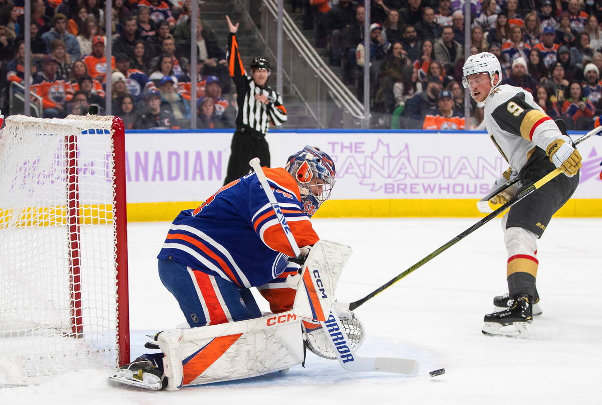 Vegas Golden Knights' Jack Eichel (9) is stopped by Edmonton Oilers goalie Stuart Skinner (74) ...