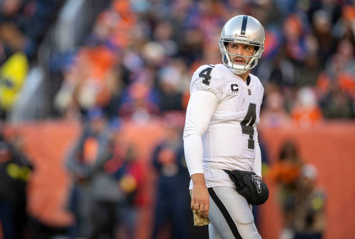 Raiders quarterback Derek Carr (4) walks the field during the first half of an NFL game against ...