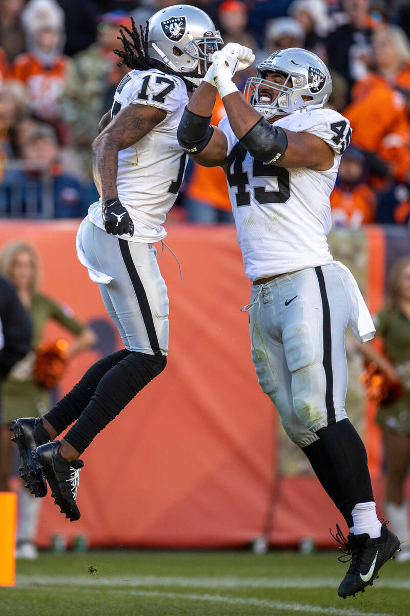 Raiders wide receiver Davante Adams (17) celebrates his touchdown with fullback Jakob Johnson ( ...