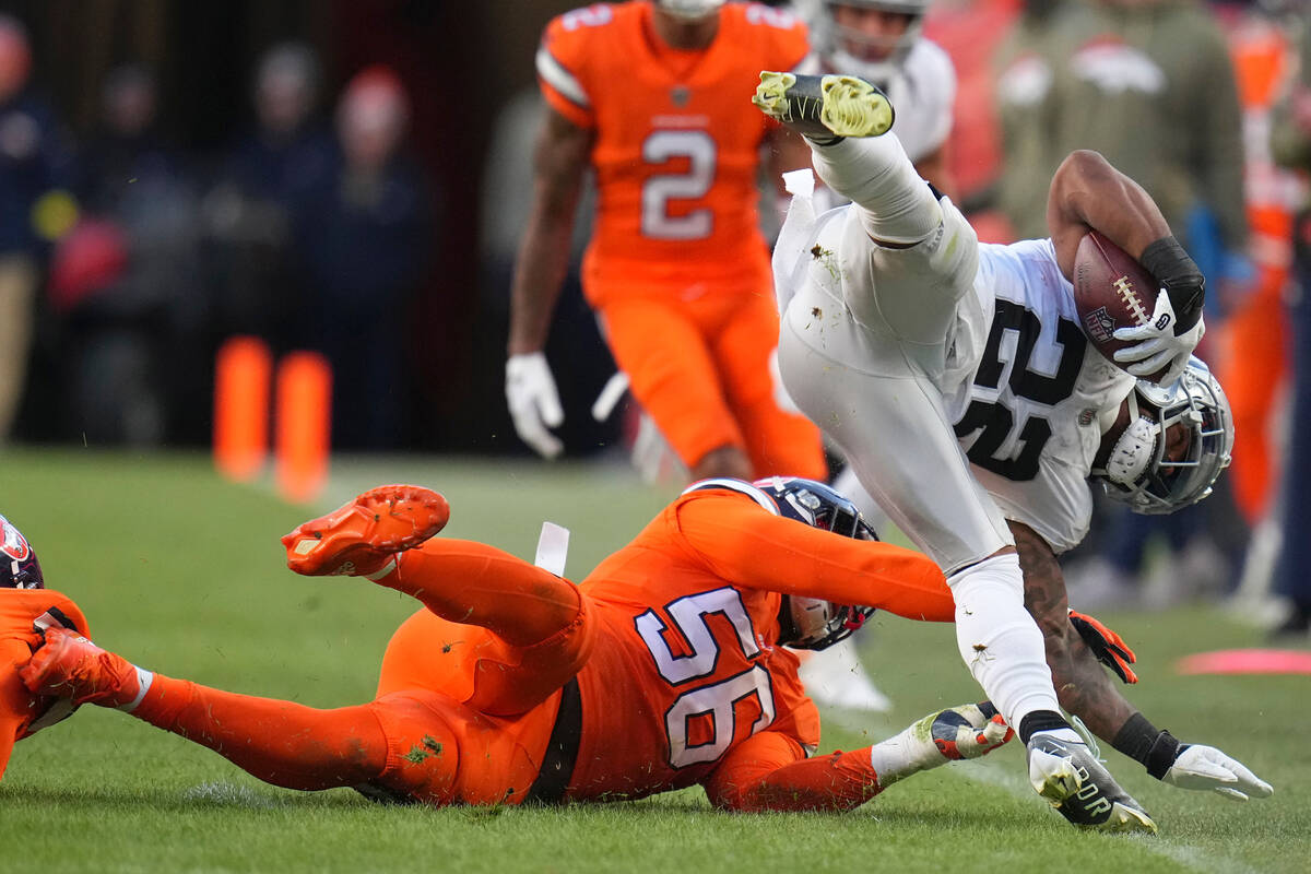 Las Vegas Raiders running back Ameer Abdullah (22) is tackled by Denver Broncos linebacker Baro ...