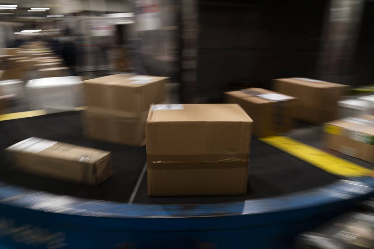 Packages move along a conveyor belt while being sorted for delivery at the FedEx regional hub a ...