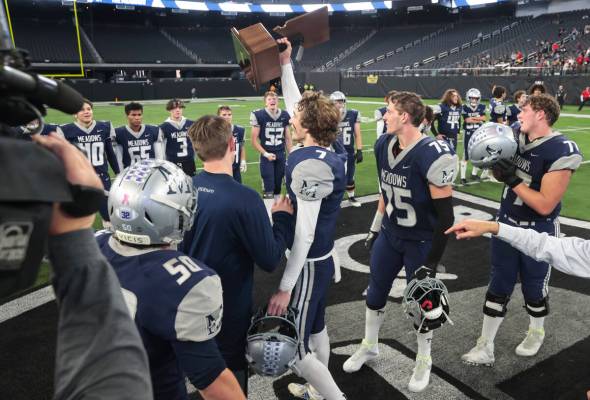 The Meadows' Sean Gosse (7) raises the trophy to celebrate after defeating Lincoln County to wi ...