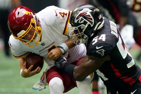 FILE - Atlanta Falcons linebacker Foye Oluokun (54) hits Washington Football Team quarterback T ...