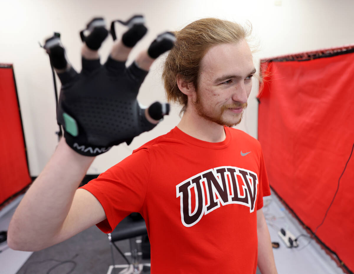 UNLV mechanical engineering student Nicolas Kosanovic demonstrates controlling a robot hand in ...