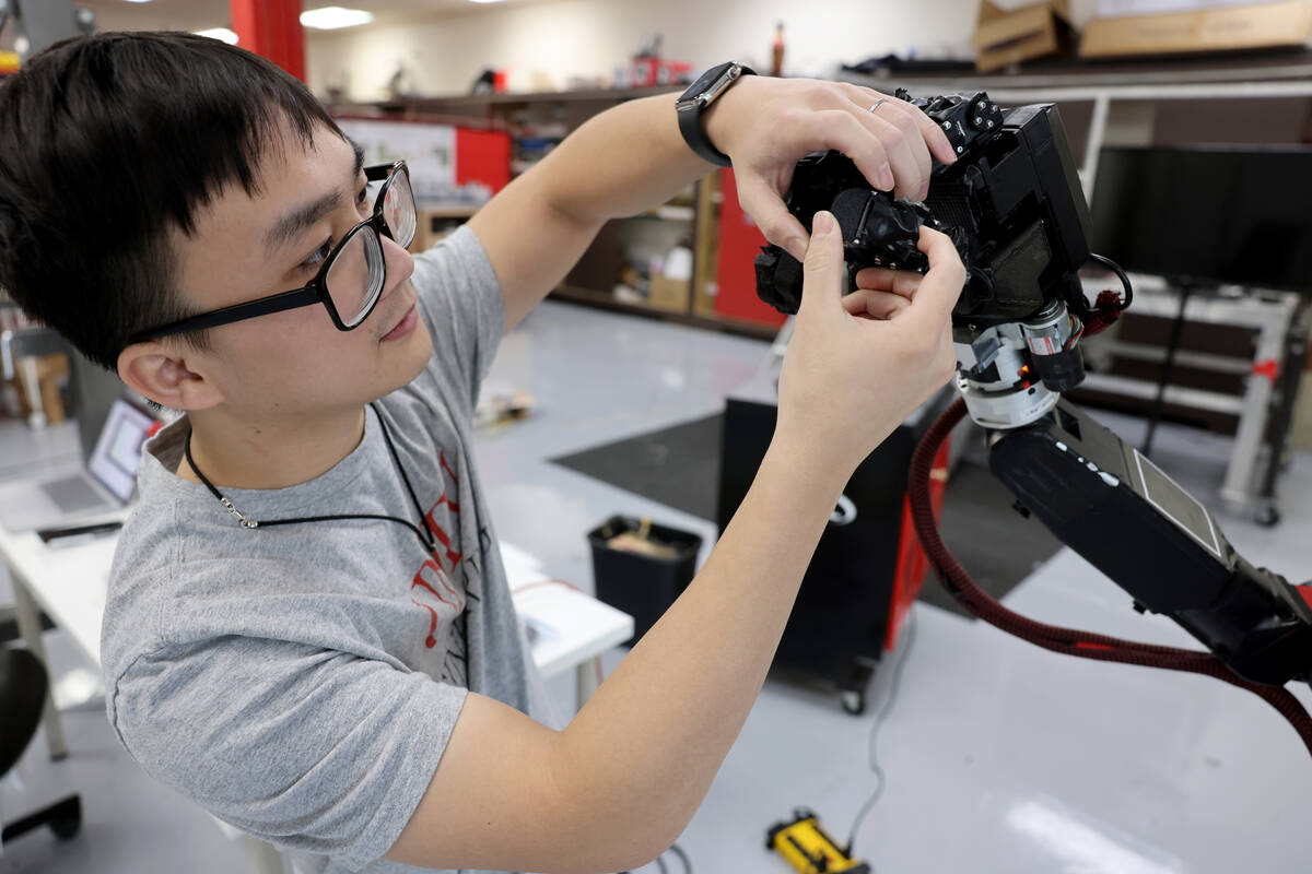 UNLV mechanical engineering grad student Truc Tran shows a robot hand he assembled in his lab i ...