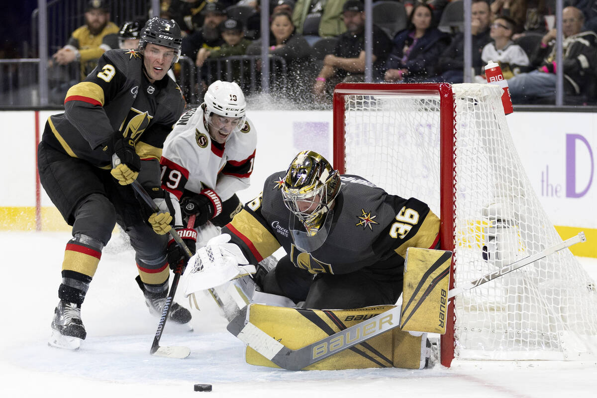 Golden Knights defenseman Brayden McNabb (3) and Senators right wing Drake Batherson (19) fight ...