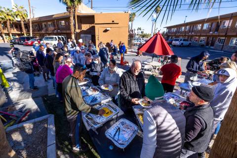 Hebron tenants are served a Thanksgiving meal there by community volunteers and Caridad Board m ...